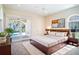 Bright bedroom with pool view, features a ceiling fan and sliding doors to the backyard at 3312 Eagles Trce, Winter Haven, FL 33884