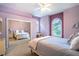 Comfortable bedroom featuring large windows and mirrored closet doors at 3312 Eagles Trce, Winter Haven, FL 33884