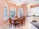 Charming breakfast nook with large windows, white cabinetry, and a ceiling fan at 3312 Eagles Trce, Winter Haven, FL 33884