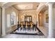 Formal dining room featuring elegant chandelier, natural light, and decorative columns at 3312 Eagles Trce, Winter Haven, FL 33884