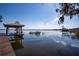Picturesque view of a dock and covered seating area on the water, offering a tranquil escape at 3312 Eagles Trce, Winter Haven, FL 33884