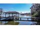 Picturesque lake view with a private boat dock featuring covered seating area and boat slip at 3312 Eagles Trce, Winter Haven, FL 33884