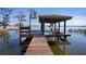 Well-maintained dock with a covered seating area and boat lift, perfect for enjoying waterfront living at 3312 Eagles Trce, Winter Haven, FL 33884