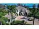 Beautiful home boasting water views, a circular driveway, and a meticulously manicured lawn at 3312 Eagles Trce, Winter Haven, FL 33884