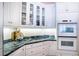 Bright kitchen with modern appliances, granite counters, and sleek white cabinetry at 3312 Eagles Trce, Winter Haven, FL 33884
