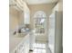 Bright laundry room with modern appliances, sink, and window at 3312 Eagles Trce, Winter Haven, FL 33884