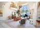 Elegant living room with a wall of windows, palm trees, grand piano, and neutral tones at 3312 Eagles Trce, Winter Haven, FL 33884