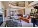 Spacious living room with high ceilings, staircase, fireplace, and grand piano at 3312 Eagles Trce, Winter Haven, FL 33884