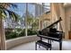 Grand piano by large window overlooking pool and waterfront at 3312 Eagles Trce, Winter Haven, FL 33884