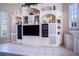 Entertainment center with shelving and storage in a living room at 3312 Eagles Trce, Winter Haven, FL 33884