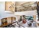 Spacious living room with dining room, wrought iron balcony, staircase, and grand chandelier at 3312 Eagles Trce, Winter Haven, FL 33884