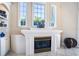 Living room fireplace with decor, windows with natural light, and tile floors at 3312 Eagles Trce, Winter Haven, FL 33884