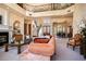 Spacious living room featuring fireplace, staircase, dining area, and wrought iron balcony at 3312 Eagles Trce, Winter Haven, FL 33884