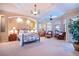 Bright main bedroom with sitting area, ensuite bath, chandelier, and bay windows at 3312 Eagles Trce, Winter Haven, FL 33884