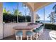Outdoor bar area with lake views and seating, perfect for entertaining or relaxation at 3312 Eagles Trce, Winter Haven, FL 33884