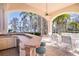 Outdoor kitchen and dining area with a bar, and views of the pool and lake offer luxury living at 3312 Eagles Trce, Winter Haven, FL 33884