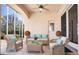 A covered patio with wicker furniture, pillows, and coffee table offers a comfy seating area at 3312 Eagles Trce, Winter Haven, FL 33884