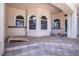 Covered outdoor patio featuring tiled flooring, arched windows, and a textured wall finish at 3312 Eagles Trce, Winter Haven, FL 33884