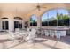 Covered outdoor patio with bar, grill, and seating perfect for dining and relaxation at 3312 Eagles Trce, Winter Haven, FL 33884