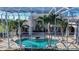 Beautiful pool inside screen enclosure with palm trees and an attached spa at 3312 Eagles Trce, Winter Haven, FL 33884