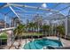 Screened pool enclosure with mature landscaping, privacy, and tiled deck offer a tranquil retreat at 3312 Eagles Trce, Winter Haven, FL 33884