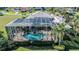 Aerial view of a private pool and screened enclosure surrounded by manicured landscaping at 3312 Eagles Trce, Winter Haven, FL 33884