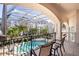 Enclosed pool area with seating offers luxurious outdoor living with privacy and a beautiful view at 3312 Eagles Trce, Winter Haven, FL 33884