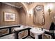Elegant powder room with ornate mirror, decorative wallpaper, and classic fixtures, plus a pedestal sink at 3312 Eagles Trce, Winter Haven, FL 33884