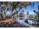 Scenic water view from the waterfront with trees draped in Spanish moss at 3312 Eagles Trce, Winter Haven, FL 33884