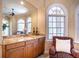Cozy wet bar area with granite countertops, custom cabinetry, and a large mirror reflecting the room at 3312 Eagles Trce, Winter Haven, FL 33884