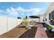 Landscaped backyard with red brick patio, vibrant plantings, and a privacy fence at 3418 Raleigh Dr, Winter Haven, FL 33884