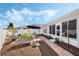 Enjoyable backyard with brick-paved patio, shade umbrella, and beautiful landscaping for outdoor relaxation at 3418 Raleigh Dr, Winter Haven, FL 33884
