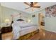 Bright bedroom with hardwood floors, a ceiling fan, and an ensuite bathroom at 3418 Raleigh Dr, Winter Haven, FL 33884