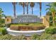 Elegant community sign surrounded by meticulously maintained landscaping and vibrant greenery at 3418 Raleigh Dr, Winter Haven, FL 33884