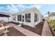 Exterior view of the home, featuring a paved walkway and landscaped surroundings at 3418 Raleigh Dr, Winter Haven, FL 33884