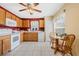 Functional kitchen with white appliances, wooden cabinets, and a charming breakfast nook at 3418 Raleigh Dr, Winter Haven, FL 33884