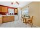 Functional kitchen featuring wooden cabinets, white appliances, and a cozy breakfast nook at 3418 Raleigh Dr, Winter Haven, FL 33884