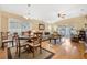 Open-concept living and dining area with wood flooring, neutral decor, and sliding glass doors at 3418 Raleigh Dr, Winter Haven, FL 33884