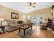 Cozy living room featuring hardwood floors, comfortable seating, and sliding doors to lanai at 3418 Raleigh Dr, Winter Haven, FL 33884