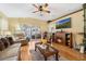 Comfortable living room with fireplace, hardwood floors, and sliding door access to lanai at 3418 Raleigh Dr, Winter Haven, FL 33884