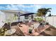 Outdoor patio boasts brick pavers, an umbrella-covered dining set, and lush landscaping at 3418 Raleigh Dr, Winter Haven, FL 33884
