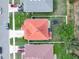 An aerial shot of a house with a bright orange roof and green backyard including a trampoline at 3526 Warbler Way, Kissimmee, FL 34746