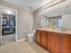 Bathroom with dual sink vanity, toilet, and a doorway leading to a walk-in closet at 3526 Warbler Way, Kissimmee, FL 34746