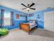 A fun bedroom with blue walls, bright curtains, and decor at 3526 Warbler Way, Kissimmee, FL 34746