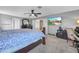 Comfortable bedroom featuring a ceiling fan, television, and modern decor at 3526 Warbler Way, Kissimmee, FL 34746