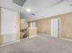 This spacious bonus room features neutral-toned walls, carpet flooring, and multiple doors at 3526 Warbler Way, Kissimmee, FL 34746