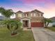 Inviting two-story home with a well manicured lawn and attached two car garage at 3526 Warbler Way, Kissimmee, FL 34746