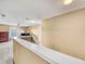 Upstairs hallway with neutral carpeting and paint, leading to an open space and filled with natural light at 3526 Warbler Way, Kissimmee, FL 34746