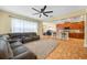 Spacious open-plan living room with a large sectional couch and tile floors at 3526 Warbler Way, Kissimmee, FL 34746