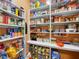 Organized pantry with shelves stocked with various food items and supplies at 3526 Warbler Way, Kissimmee, FL 34746